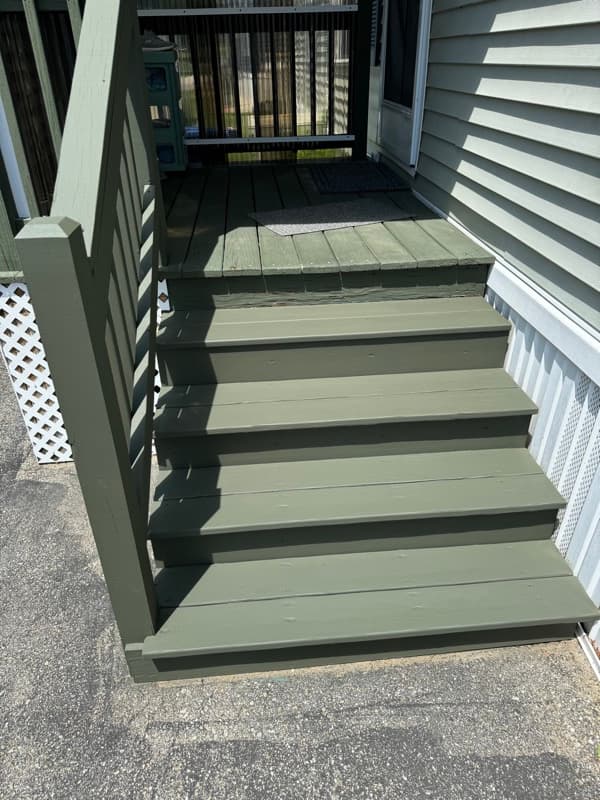 Freshly painted green deck boards and railing in Salem, NH