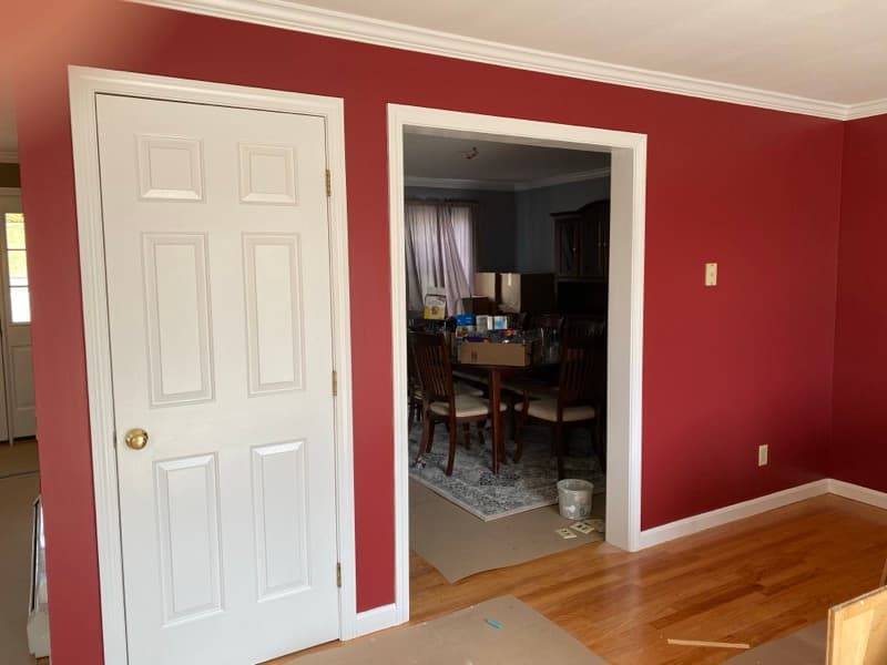 Room with deep burgundy walls and crisp white trim in Haverhill, MA