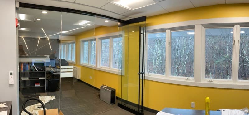 Office with curved mustard yellow accent wall and large windows in Salem, NH