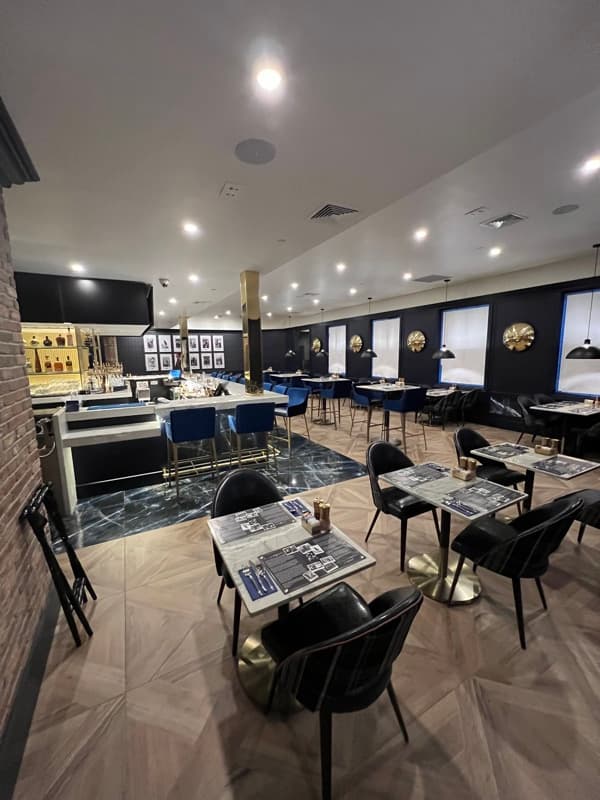 Upscale restaurant with navy blue panels and gold accents in Seabrook, NH
