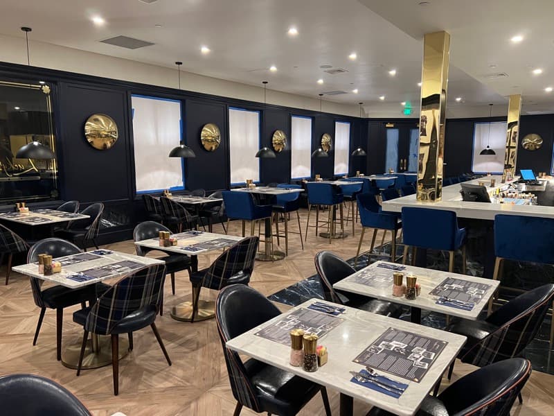 Restaurant dining room with navy walls and gold medallion decorations in Seabrook, NH
