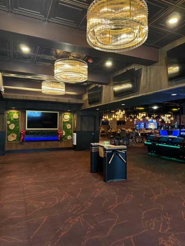 Upscale commercial lobby with dark walls and crystal chandeliers in Seabrook, NH