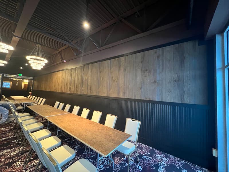 Wood-paneled accent wall with dark wainscoting in a commercial banquet hall in Seabrook, NH
