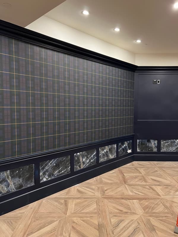 Commercial hallway with dark navy walls and decorative wood paneling in Seabrook, NH